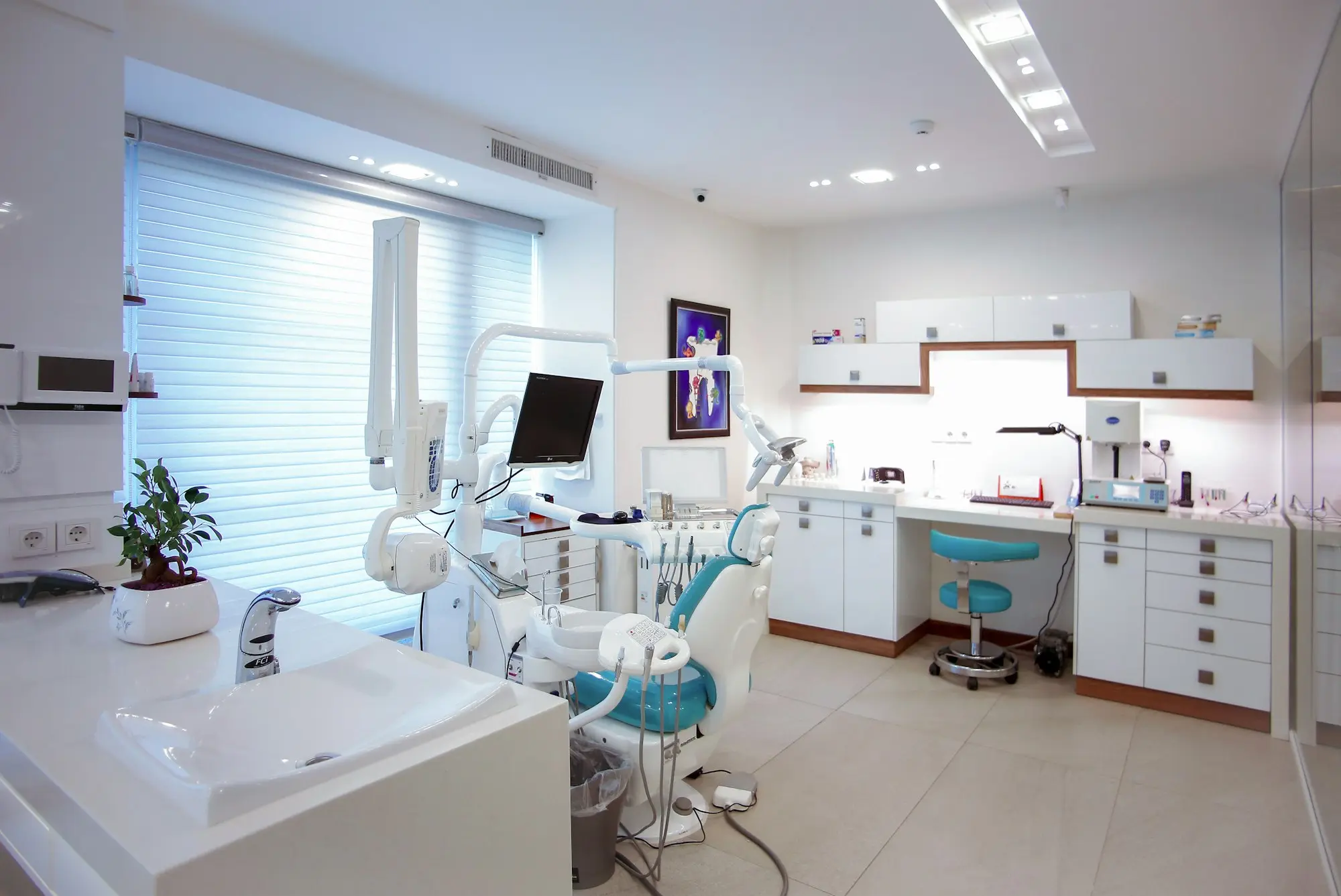 A bright, tidy dental surgery with daylight from a large window