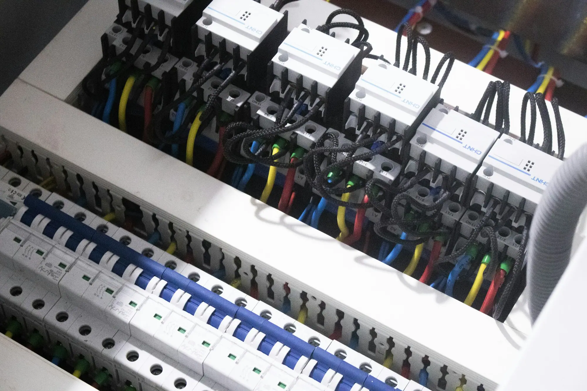 A newly installed consumer unit with a row of circuit breakers, neatly wired