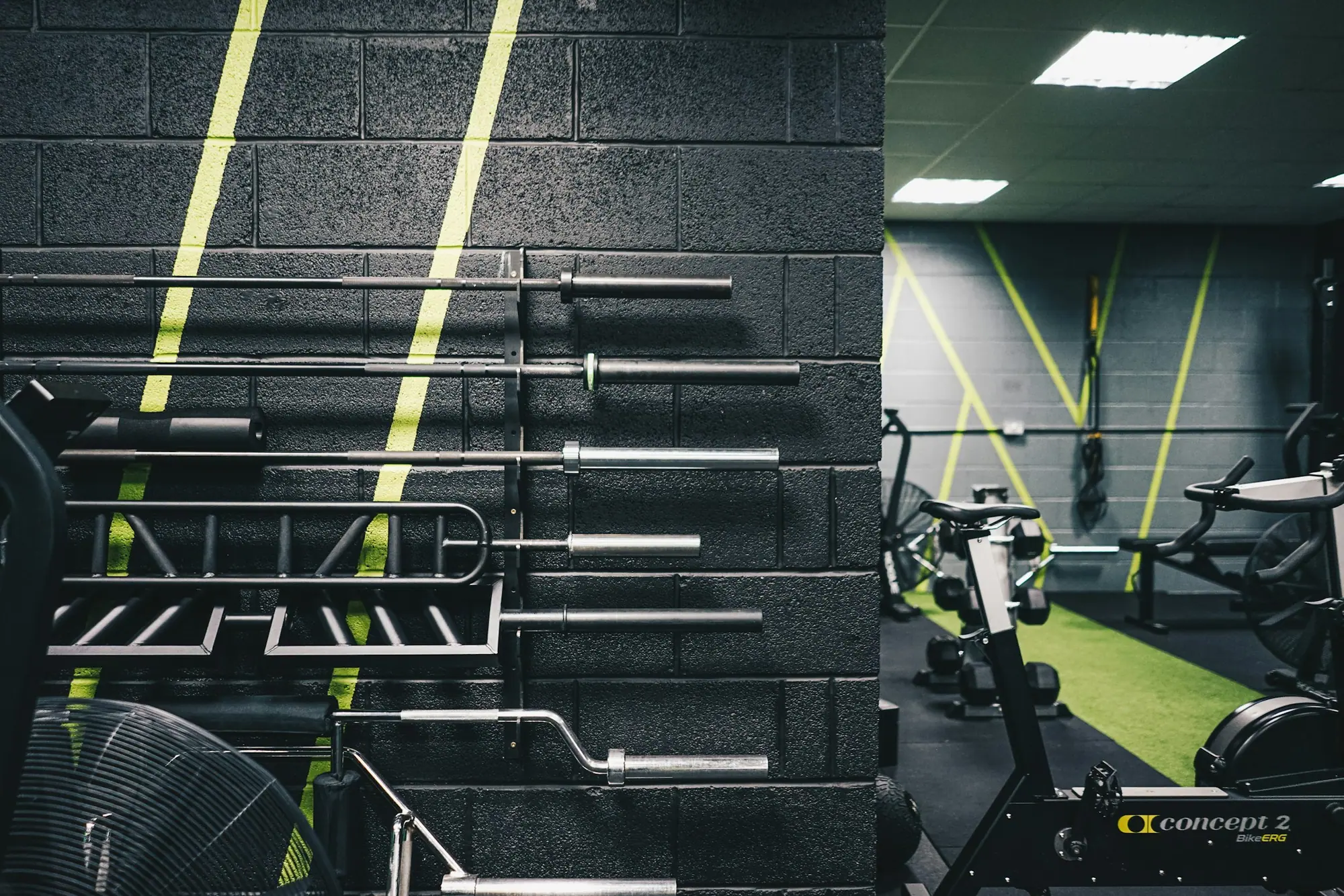 The gym floor at Apex, racks and benches under low light