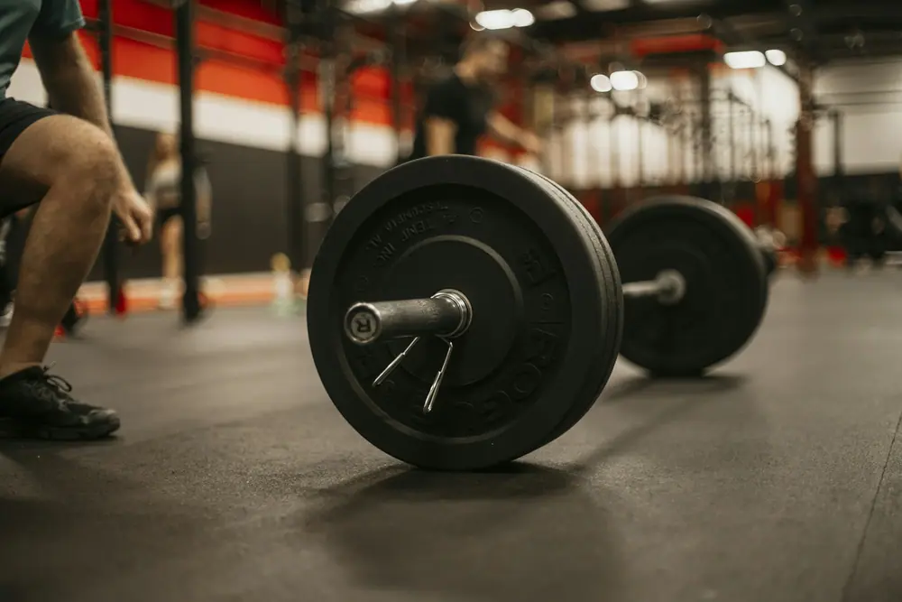 A lifter mid squat with a barbell across the shoulders