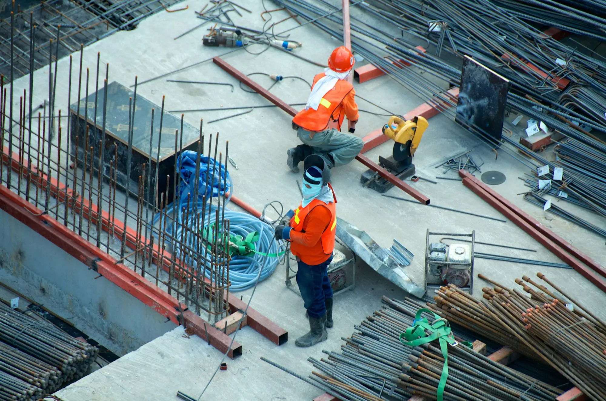 Groundworks crew setting steel reinforcement on a commercial slab